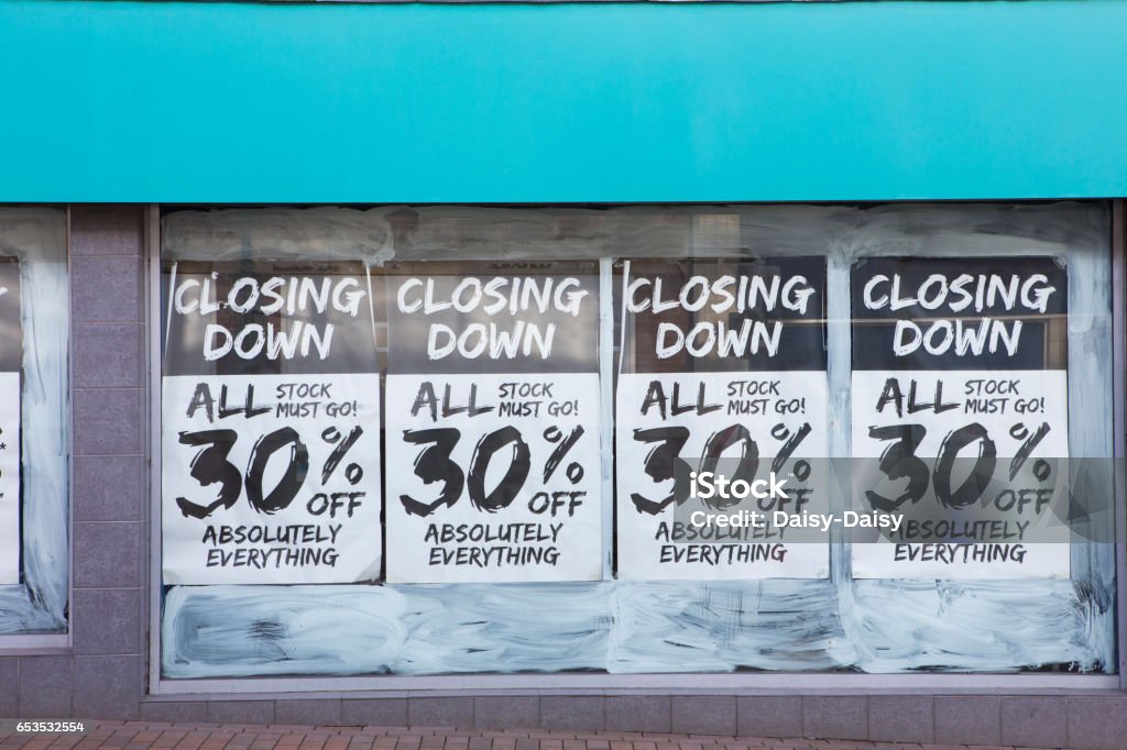 Exterior Of Shop With Closing Down Notice In Window Going Out Of Business Stock Photo