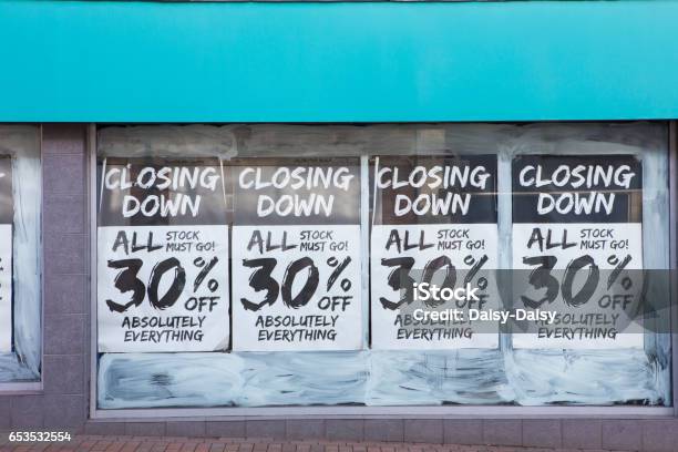 Exterior Of Shop With Closing Down Notice In Window Stock Photo - Download Image Now