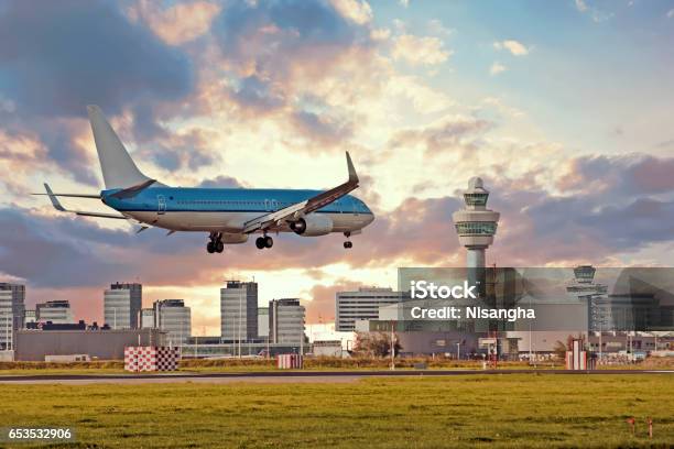 Airplane Landing On Schiphol Airport In Amsterdam In The Netherlands Stock Photo - Download Image Now