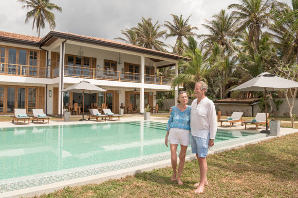 istock Senior couple in hotel grounds standing by swimming pool 653532962
