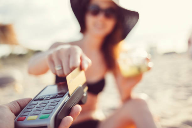 istock Tourist paying with credt card on the beach 653533932