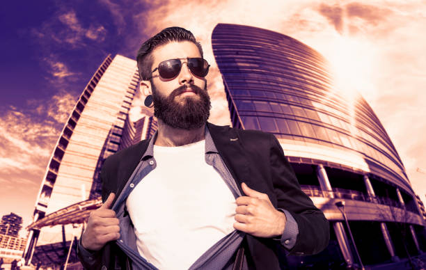 young hipster superhero is protecting the city in front of a skyscraper
