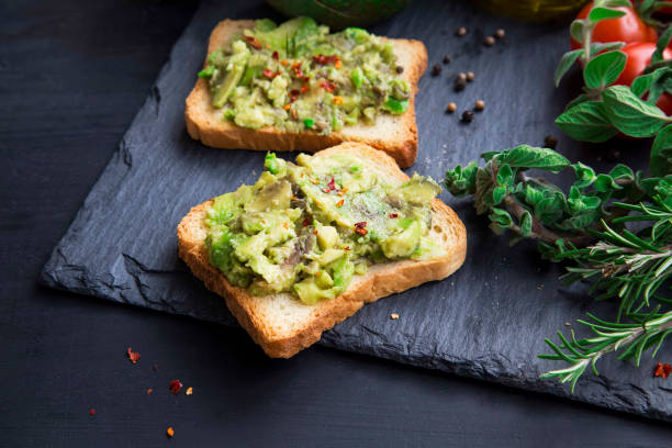 Avocado on toast with chili flakes , herbs and cherry tomatoes Avocado on toast with chili flakes , herbs and cherry tomatoes egg cherry tomato rye stock pictures, royalty-free photos & images