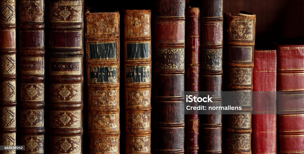 old books with vintage bindings and beautiful gilded leather book covers isolated image of old book covers, vintage book bindings, spines Old Book Stock Photo