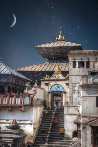 Freely walk monkey. Votive temples and shrines in a row at Pashupatinath Temple, Kathmandu, Nepal. night stars shine and the moon