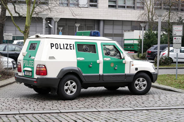 Magdeburg, Germany – March 07, 2017: Armored police car as escort for a money transport in the inner city of Magdeburg