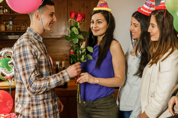 istock Boyfriend gives his girlfriend red roses 653546318