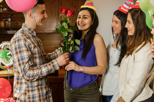 istock Boyfriend gives his girlfriend red roses 653546606