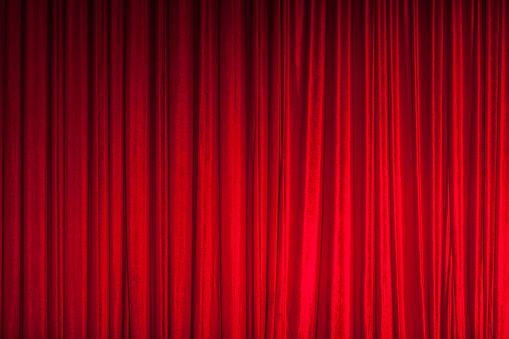 Background of red spotted real theatrical curtain or drapes texture