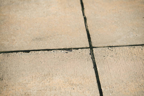 istock Empty gray concrete airport runway closeup with black sealant between concrete expansion joints. 653602588