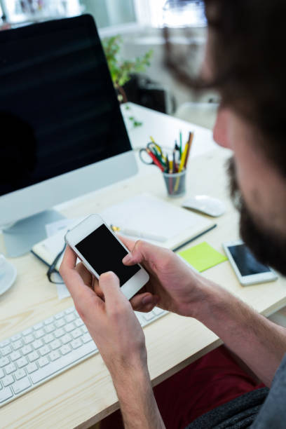 istock Business executive looking at clipboard at his desk 653610358