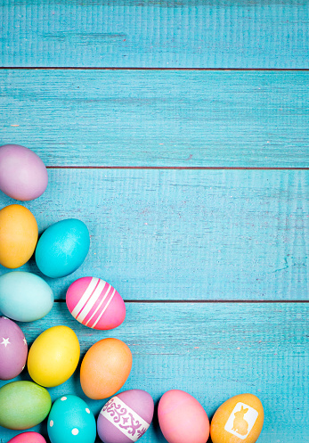 Colorful Easter Eggs arranged on a blue background.