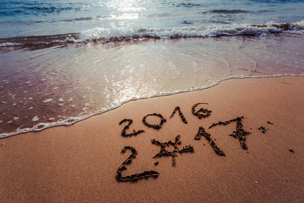istock Happy New Year 2017 on the beach 653707452