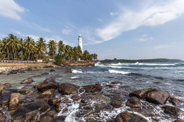 istock Beautiful lighthouse, landscape tropical rocky beach. 653712892