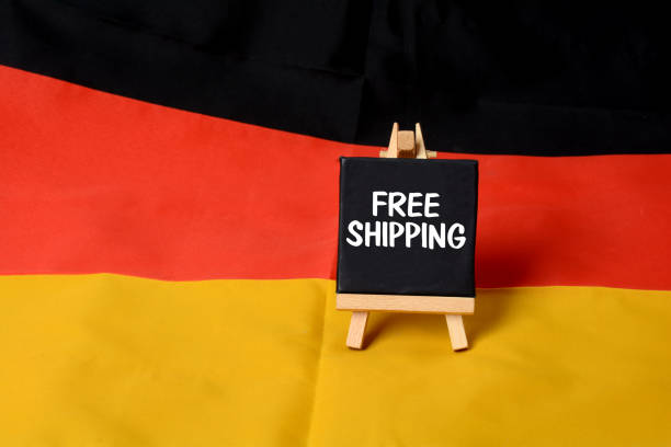 istock Free Shipping Sign on German Flag background 653747940