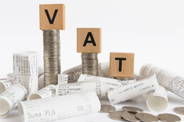 VAT decoration with receipts Rows of coin stacks with toy blocks among the receipts  symbolizing value added tax vat stock pictures, royalty-free photos & images