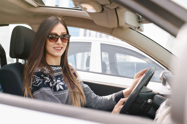 istock Young woman driving car 653753194