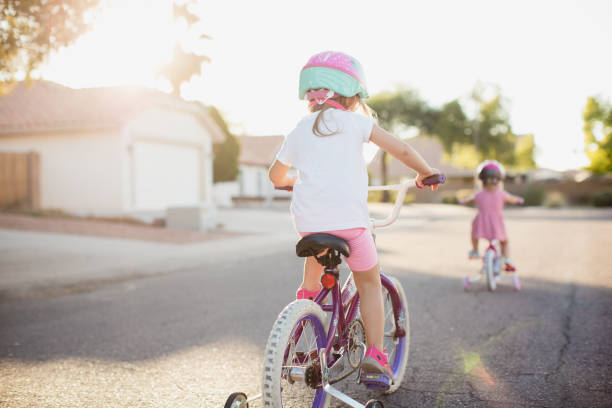 Young Girls Riding Bikes stock photo