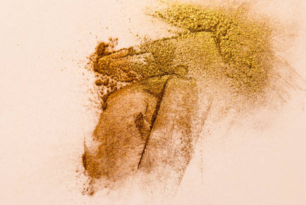 istock Golden and orange powder pigments on white sheet 653755936