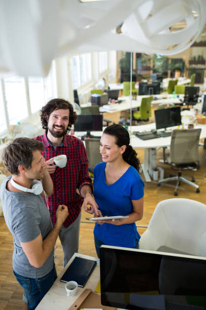 istock Team of graphic designers discussing over digital tablet 653756182