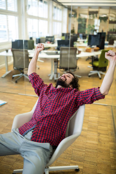 istock Business executive clenching fist in office 653761448