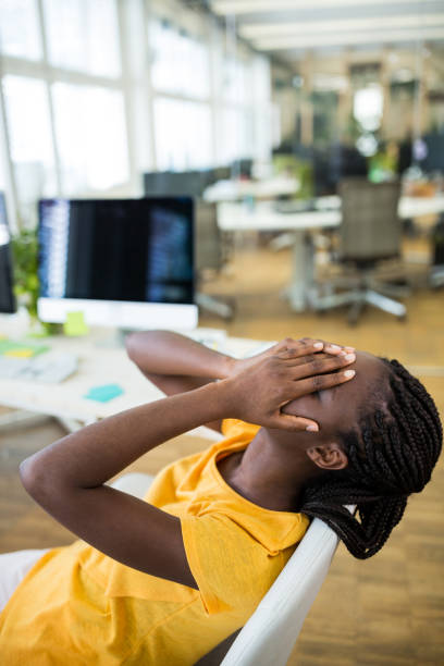 istock Frustrated female business executive at desk 653761572