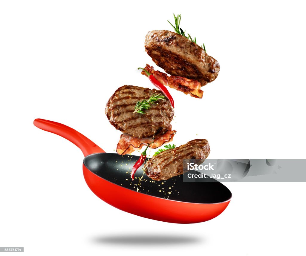 Beef milled meat flying from a pan on white background Beef milled meat flying from a pan, isolated on white background Food Stock Photo