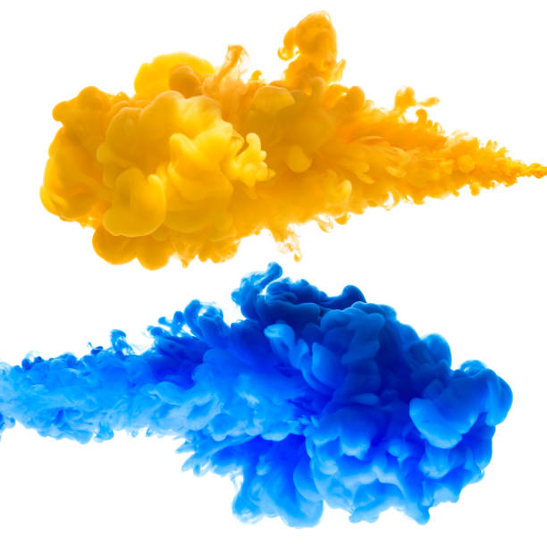 istock Yellow and blue ink splashes in the water 653763884