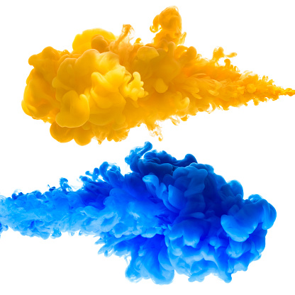Yellow and blue ink splashes in the water, isolated on white background