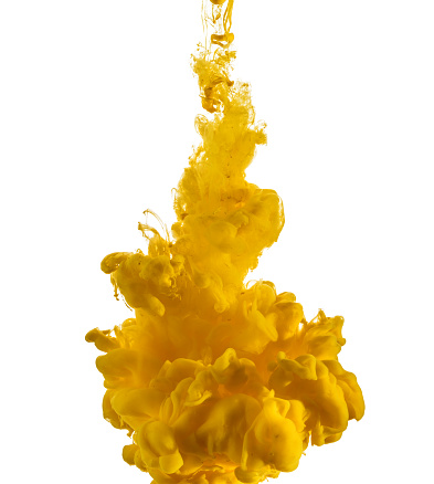 Yellow ink drop flowing in water, isolated on white