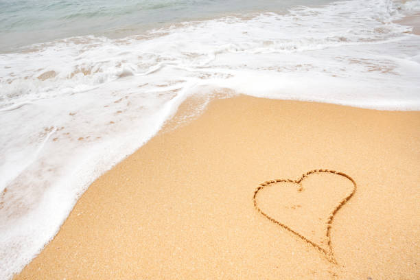 istock heart on the sea beach 653764010