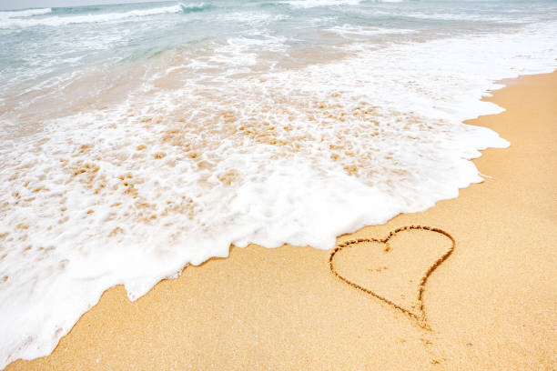 istock heart on the sea beach 653764024