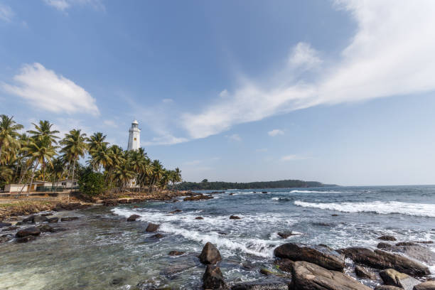 istock Beautiful lighthouse, landscape tropical rocky beach. 653764078