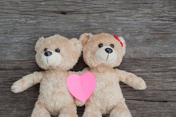 istock teddy bear lying on the wooden floor 653764674