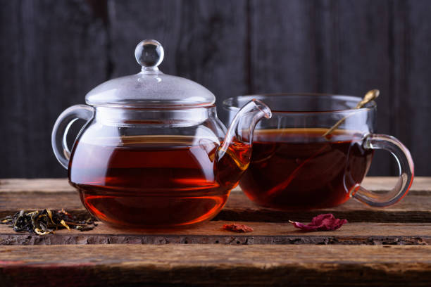 istock Glass teapot and cup with hot tea 653764684