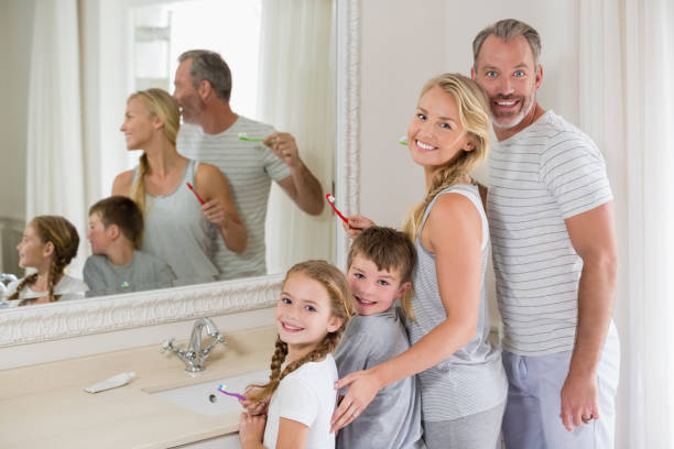 istock Parents and kids brushing teeth in bathroom 653765028