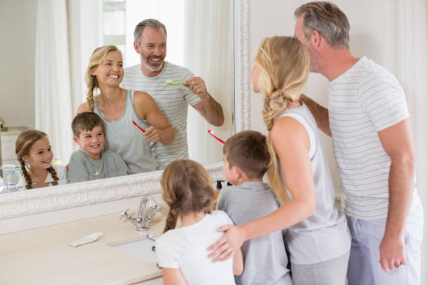 istock Parents and kids brushing teeth in bathroom 653765038