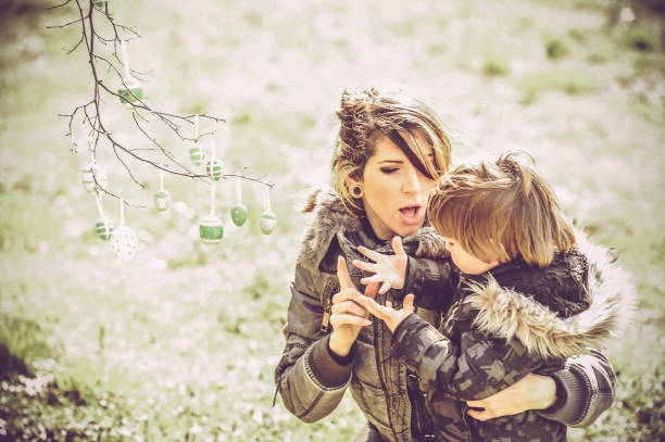 mother with her little boy outdoors - outdoors playing family spring imagens e fotografias de stock