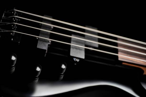 istock Sleek black bass guitar closeup 653767684