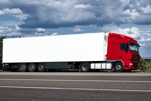 istock Truck on road with white blank container, blue sky, cargo transportation concept 653769226