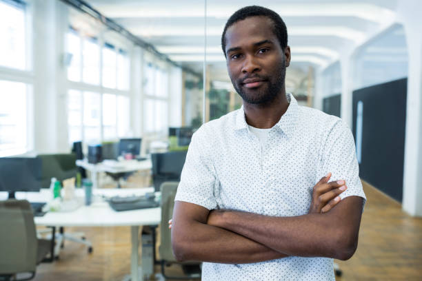 istock Graphic designer standing with arms crossed in office 653770210