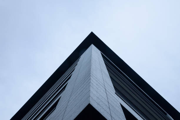 istock Corner of a skyscraper under a cloudy and cold sky seen from the bottom 653771286