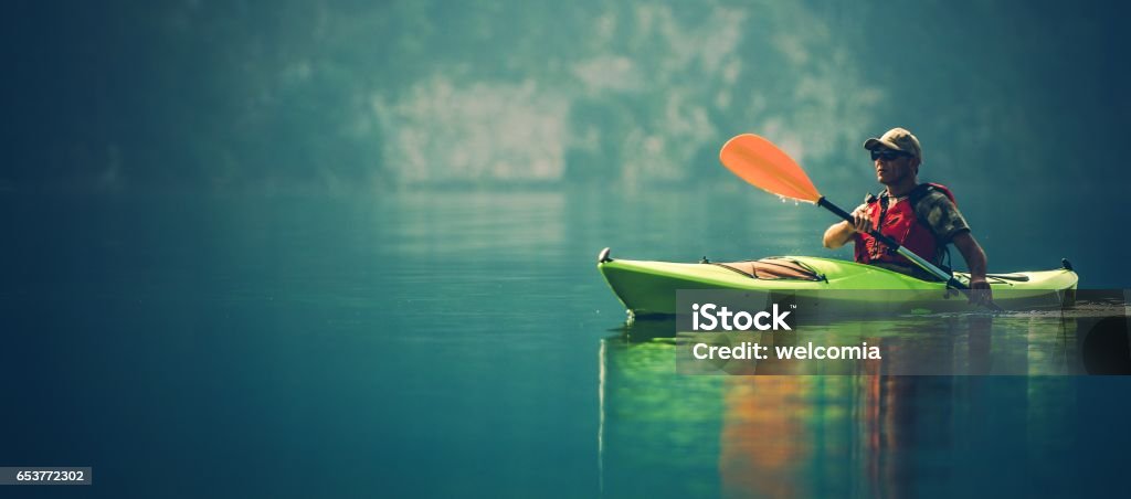 Kayak Water Sports Banner Kayak Water Sports Banner with Copy Space. Senior Kayaker on the Scenic Lake Panoramic Photo. Kayaking Stock Photo