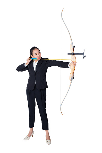 Portrait of concentrated female with crossbow in hands over white background