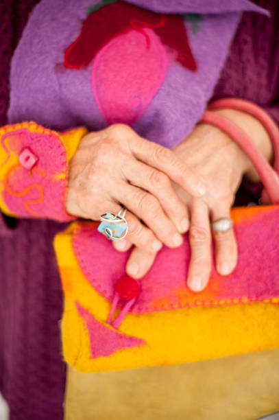 istock Beautiful Senior Woman In Multi Colored Outfit - Close Up Hands 653772976