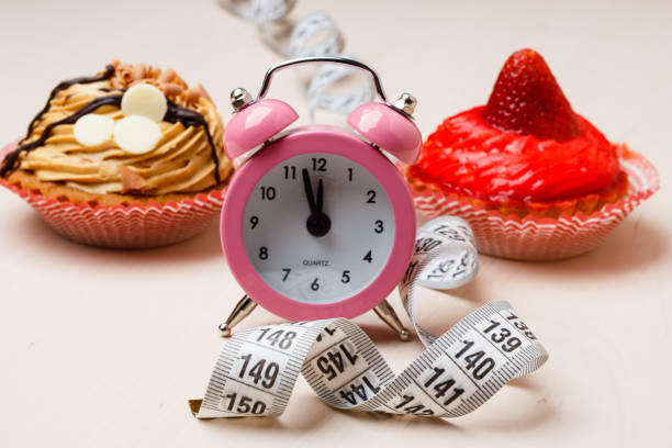istock Sweet food measuring tape and clock on table 653773246