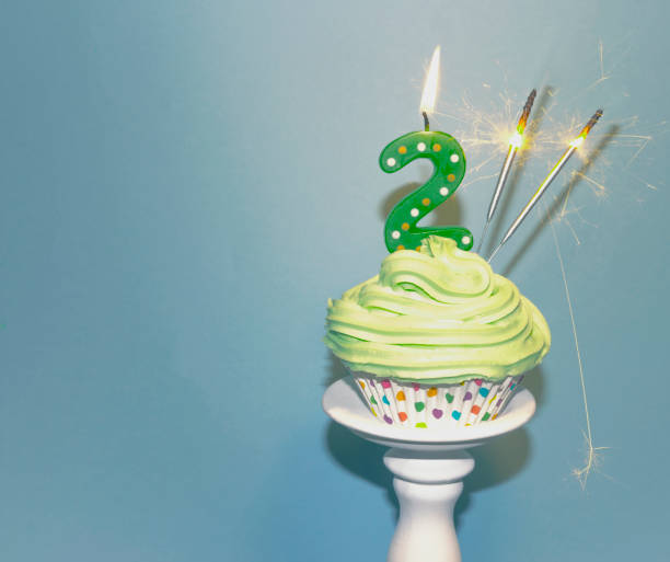 Happy Birthday 2 Today Happy Birthday 2 Today Cupcake with number two candle birthday cake green stock pictures, royalty-free photos & images