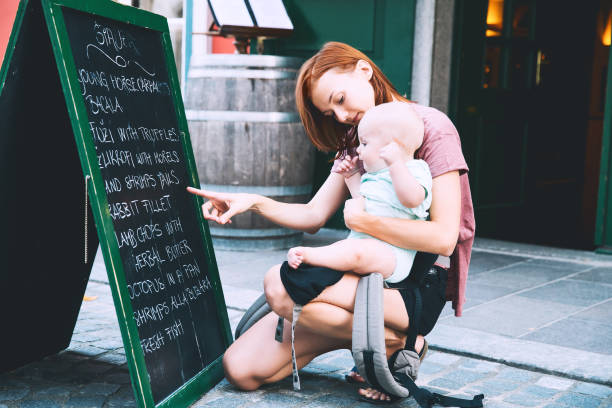 beautiful young mother with baby child spend time in the old town of ljubljana, slovenia, europe. - child women outdoors mother imagens e fotografias de stock
