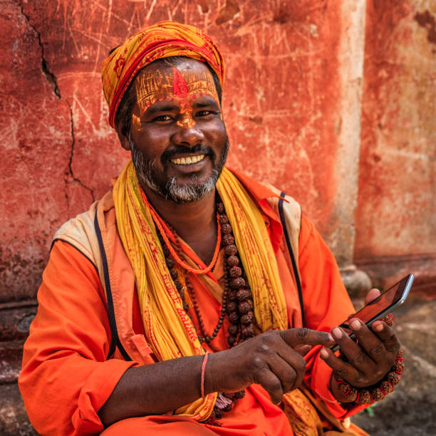 istock Sadhu - indian holyman using mobile phone 653776582