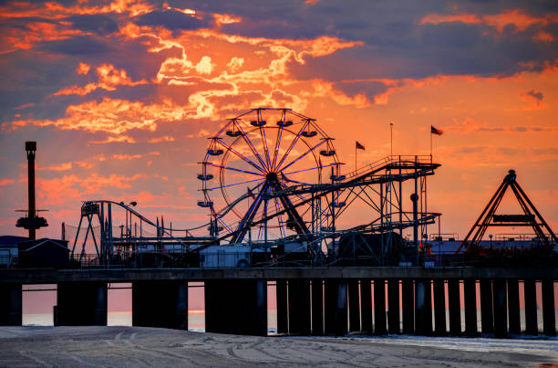 The iconic Steel Pier on the Atlantic City Boardwalk The iconic Steel Pier on the Atlantic City Boardwalk. Atlantic City is known for its two mile long boardwalk, gambling casinos, great nightlife, beautiful beaches, and the Miss America Pageant ferris wheel stock pictures, royalty-free photos & images